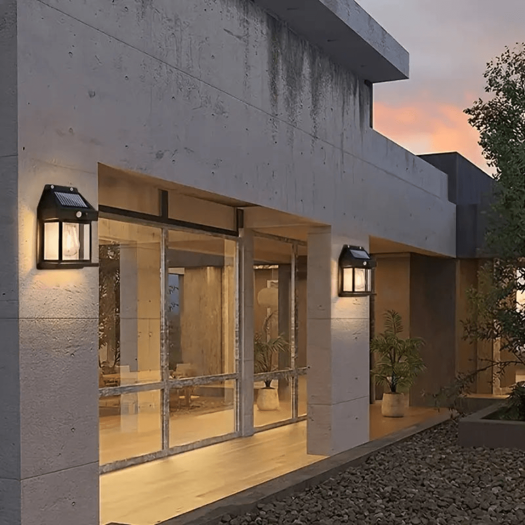Path beside a house lit by several modern solar lamps at night