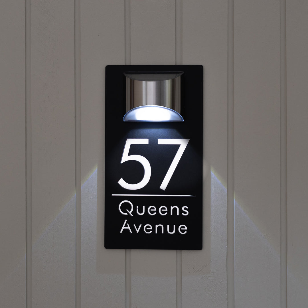 Modern house number sign with LED light on a door