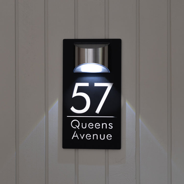 Modern house number sign with LED light on a door