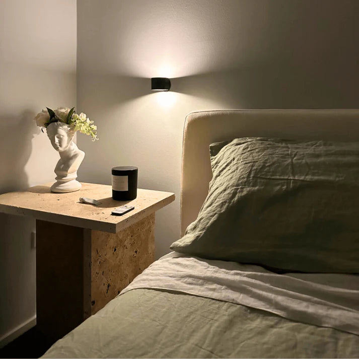 Hallway wall lit softly by a cordless LED wall lamp