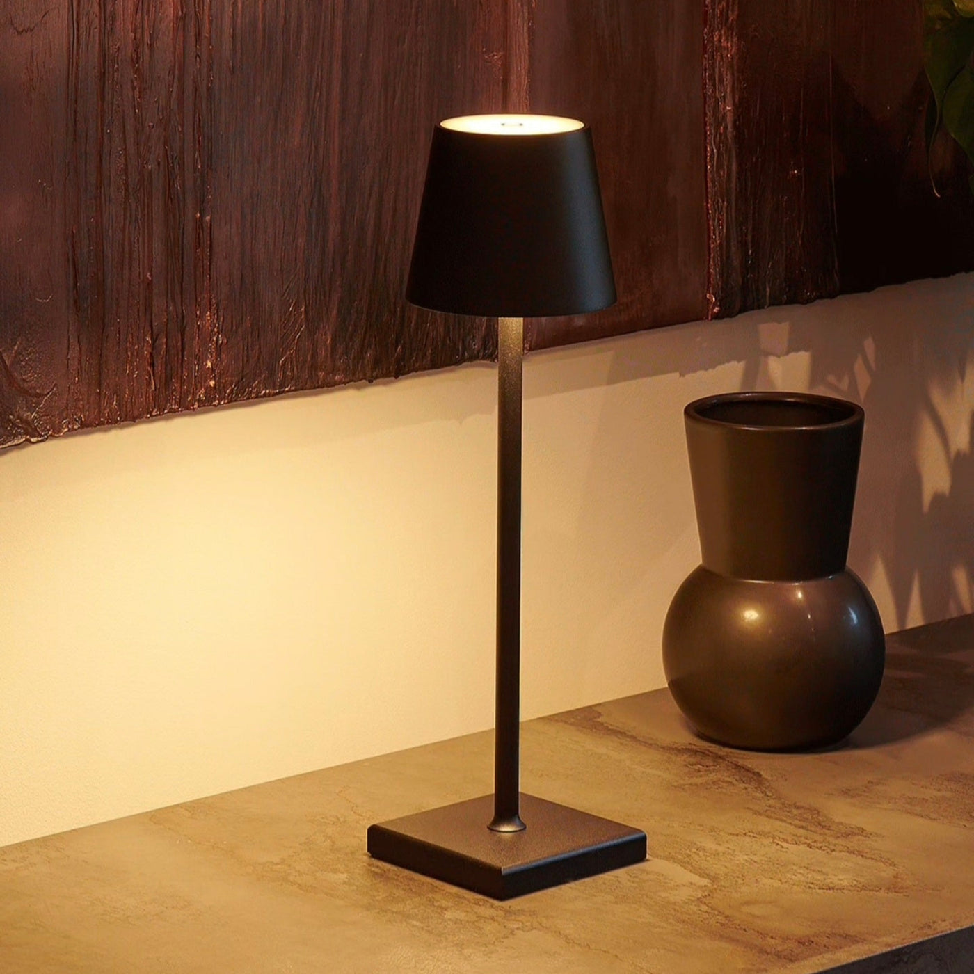 Cordless metal table lamp in black, gold and white finishes side by side